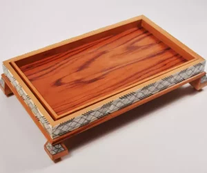 Large handcrafted wooden tray, carefully crafted and decorated with intricate mother-of-pearl inlays for an open buffet.
