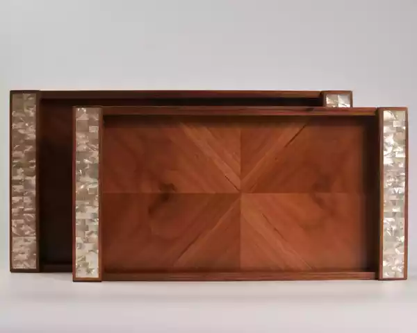 A set of handmade rectangular wooden trays inlaid with pearl pieces in a wonderful geometric shape