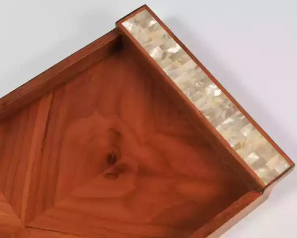 A set of handmade rectangular wooden trays inlaid with pearl pieces in a wonderful geometric shape