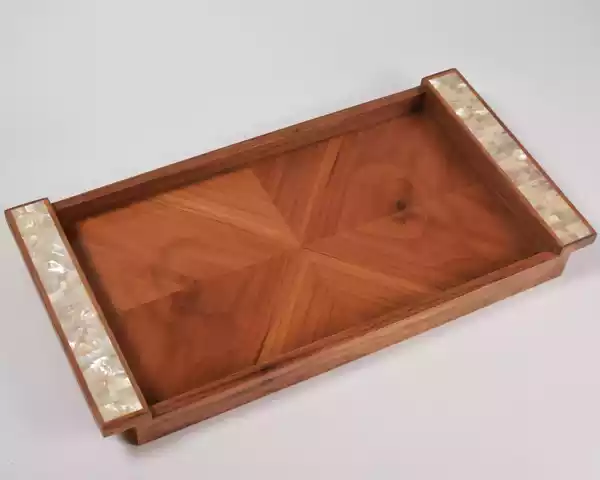 A set of handmade rectangular wooden trays inlaid with pearl pieces in a wonderful geometric shape