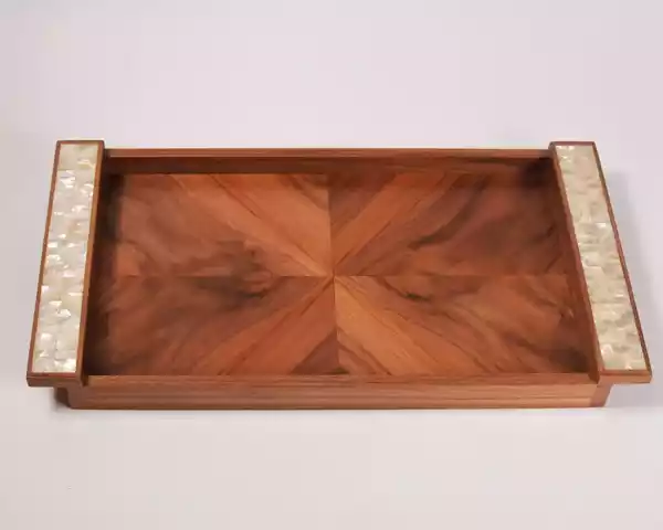 A set of handmade rectangular wooden trays inlaid with pearl pieces in a wonderful geometric shape
