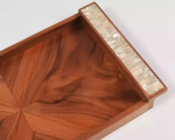A set of handmade rectangular wooden trays inlaid with pearl pieces in a wonderful geometric shape