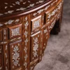Handmade round wooden table inlaid with natural mother-of-pearl