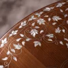Handmade round wooden table inlaid with natural mother-of-pearl